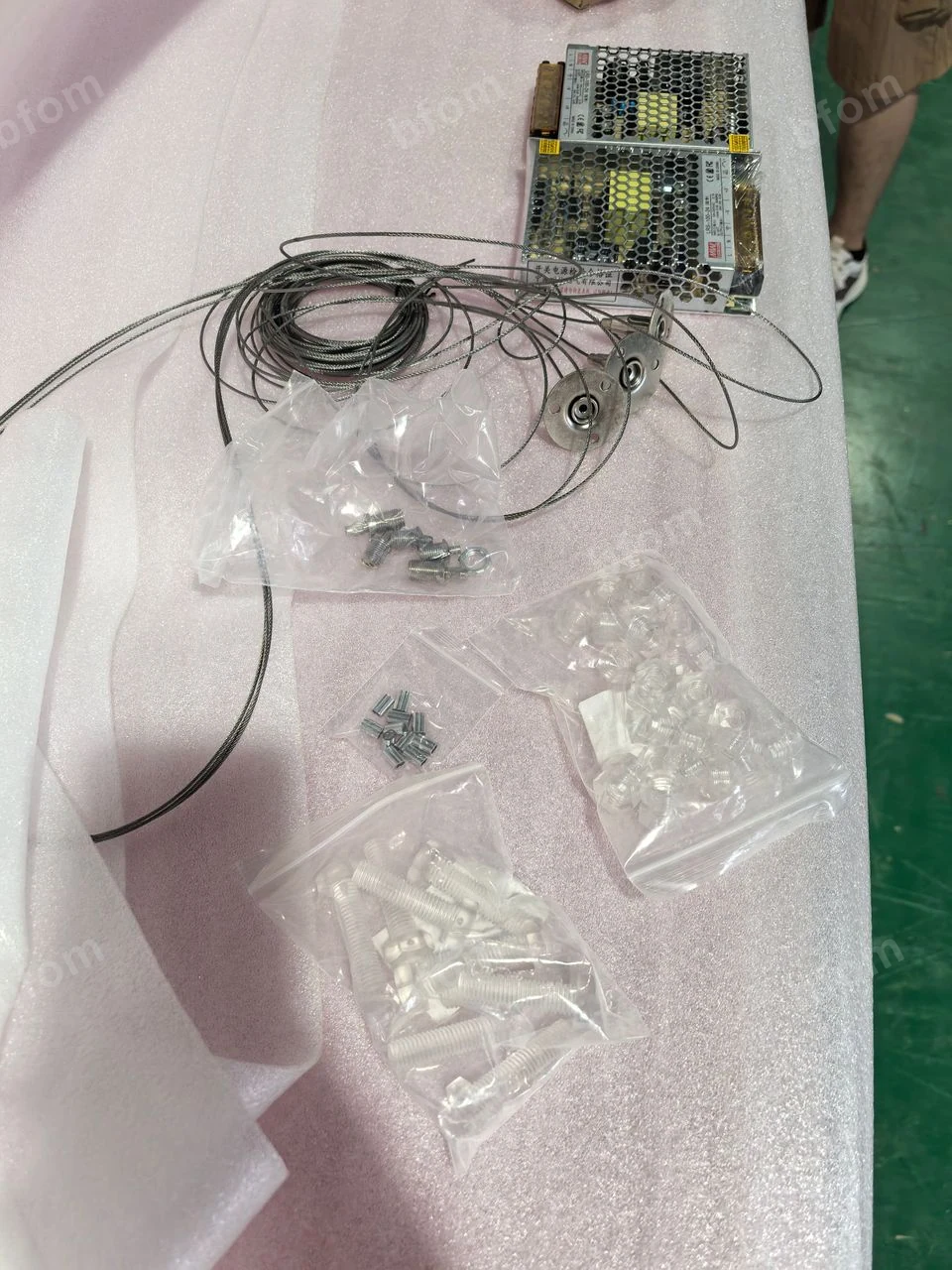 LED strips, drivers and fixing components prepared for a backlit assembly